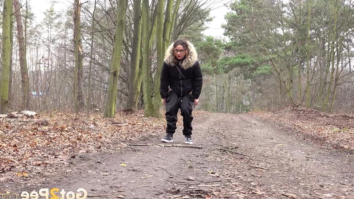 15P Solo girl Natasha Ink squats for a pee on a dirt road in glasses and a coat