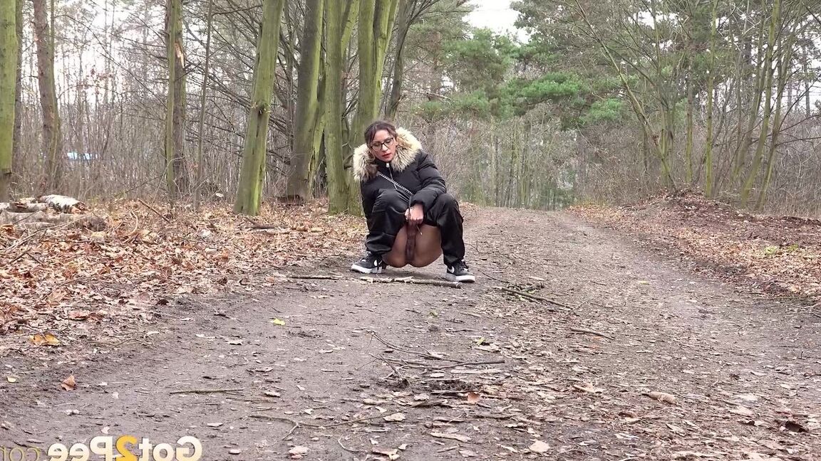 15P Solo girl Natasha Ink squats for a pee on a dirt road in glasses and a coat