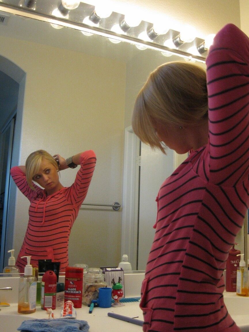 16P Blonde amateur Tiny Tiff sports a whale tail while doing her hair in a mirror