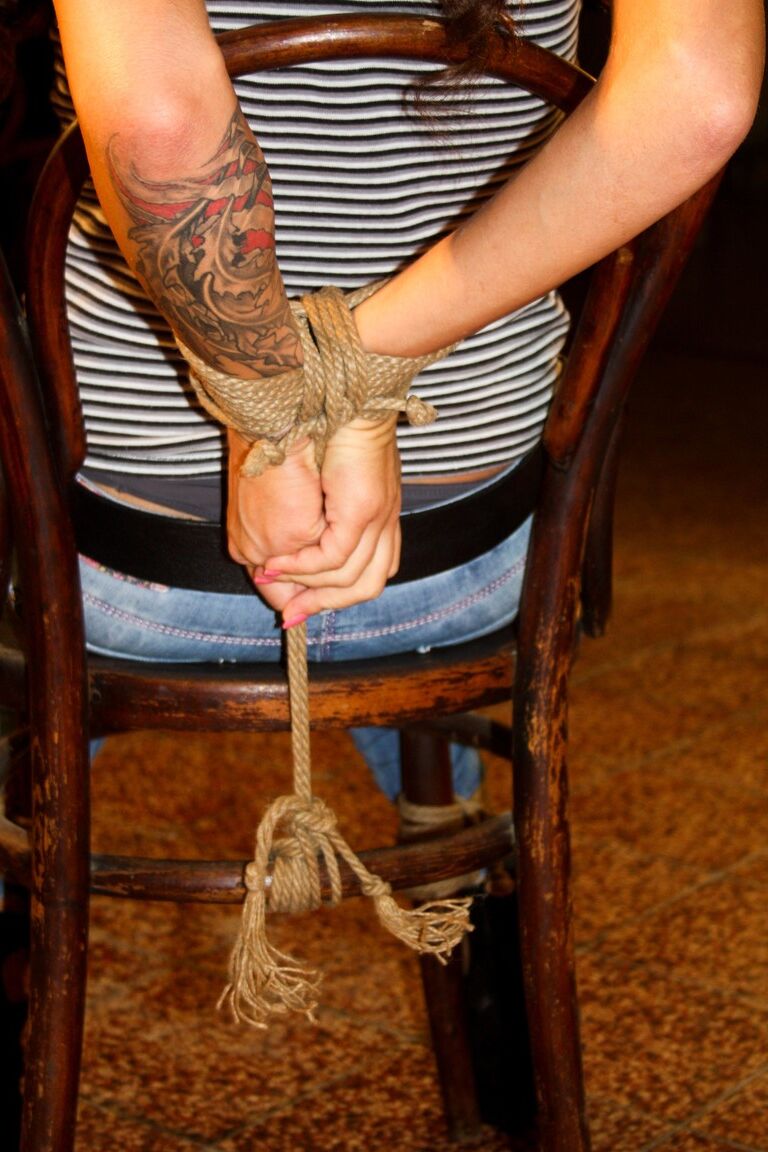 17P Ball gagged female struggles against rope restraints in ripped denim jeans