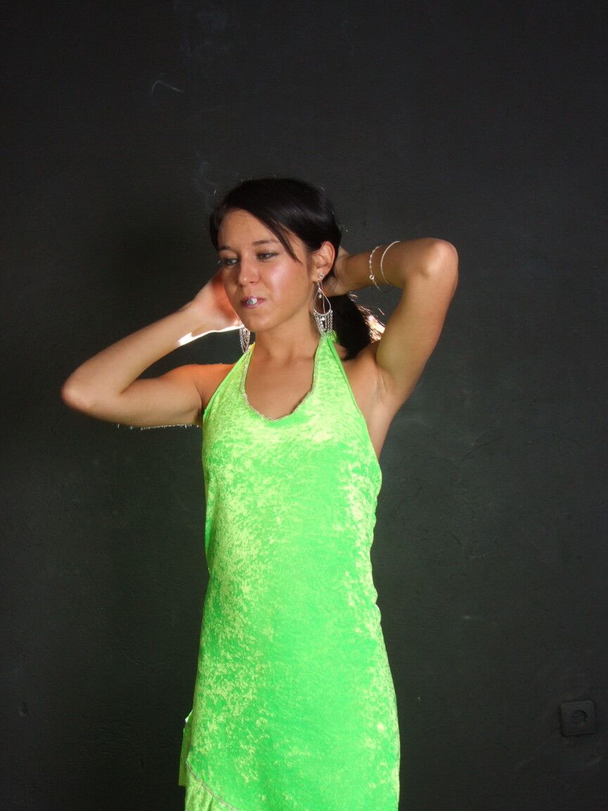 16P Dark haired teen wears a lime dress and pointy heels while smoking