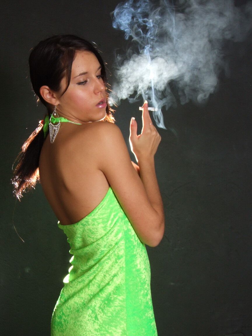 16P Dark haired teen wears a lime dress and pointy heels while smoking