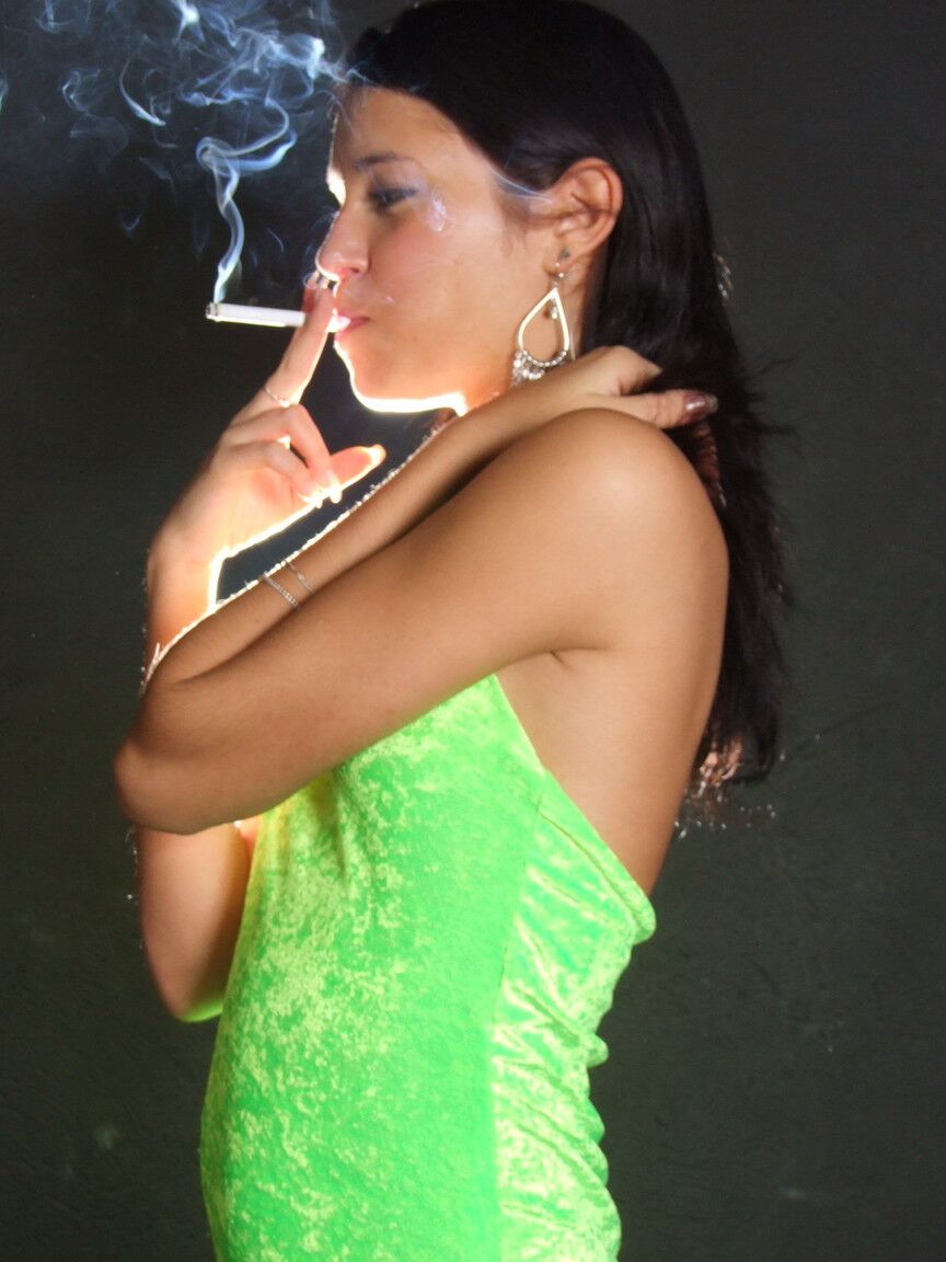 16P Dark haired teen wears a lime dress and pointy heels while smoking