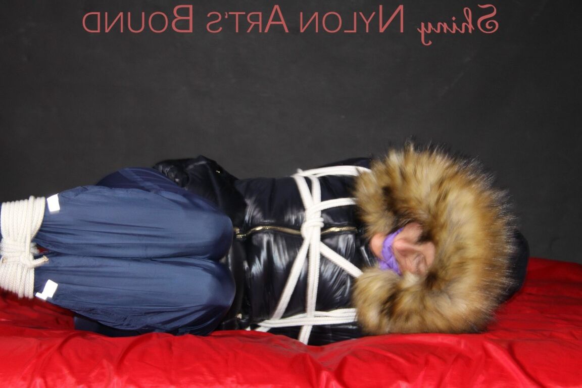 16P Sonja being tied, gagged and hooded on a shiny nylon bed with ropes and a