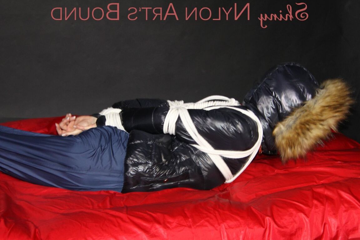 16P Sonja being tied, gagged and hooded on a shiny nylon bed with ropes and a