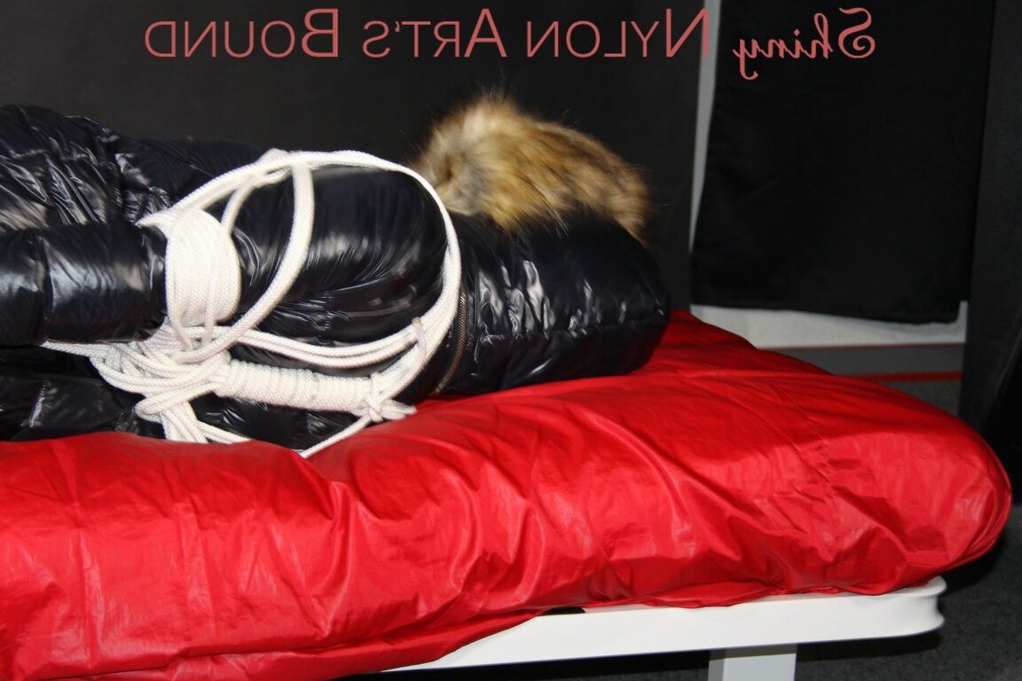 16P Sonja being tied, gagged and hooded on a shiny nylon bed with ropes and a