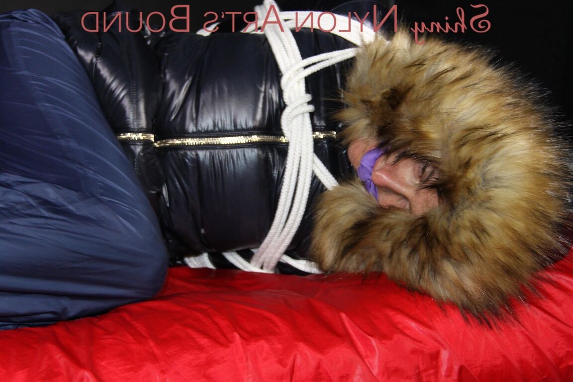16P Sonja being tied, gagged and hooded on a shiny nylon bed with ropes and a