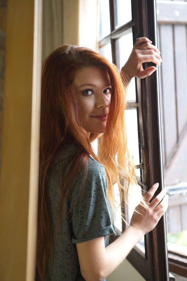 12P Natural redhead Mia Sollis stands totally naked after disrobing at home