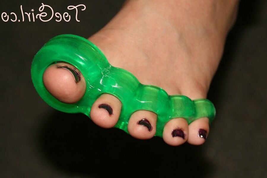 16P Caucasian girl dons toe spreaders before painting her toenails