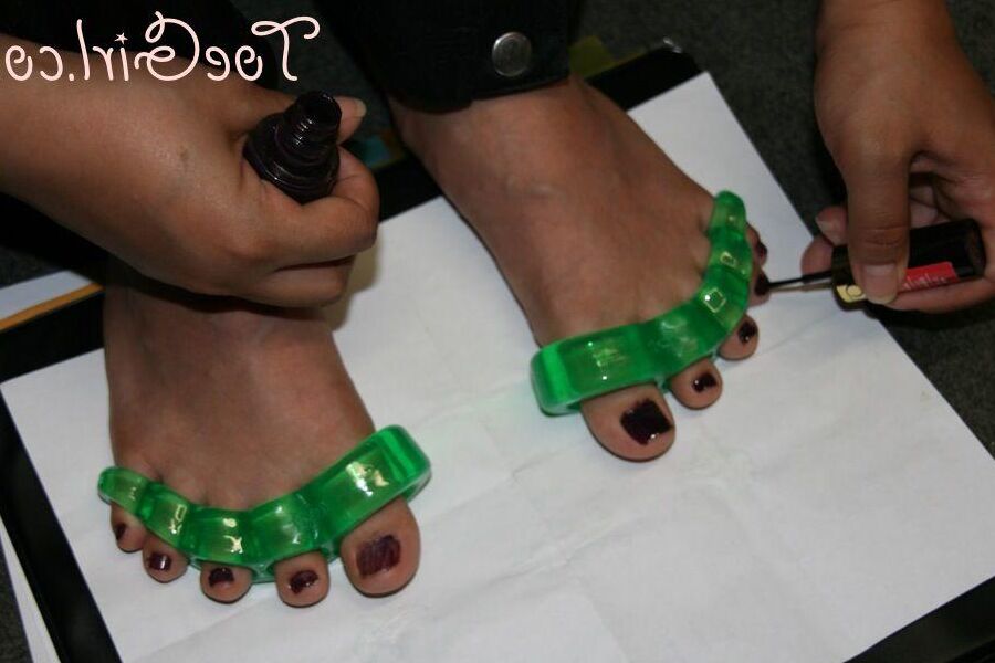 16P Caucasian girl dons toe spreaders before painting her toenails