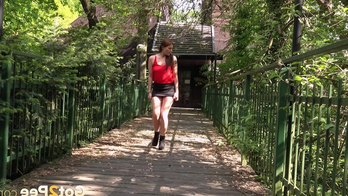 15P Distressed girl Dreka squats to pee on a path in woods with the loo locked up