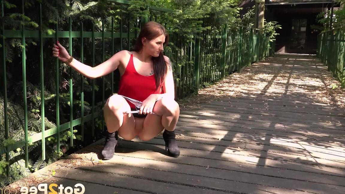 15P Distressed girl Dreka squats to pee on a path in woods with the loo locked up