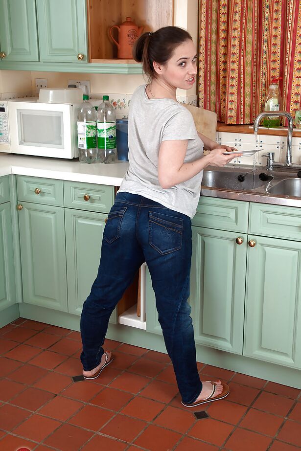 16P European babe in jeans strips off in the kitchen and squats showing hairy cunt
