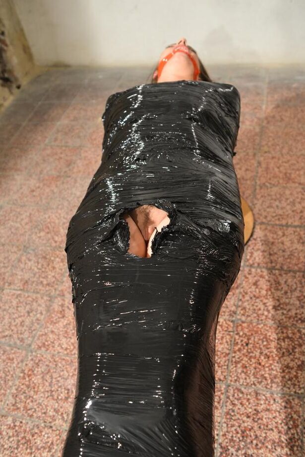 15P Naked female in high heeled shoes only is mummified in plastic and gagged