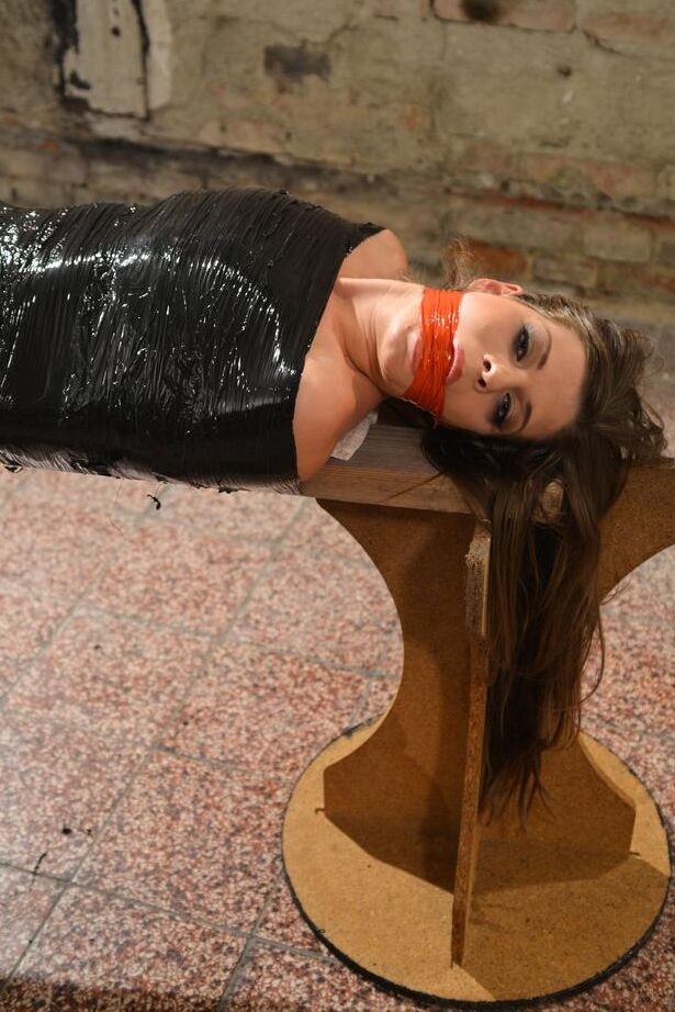 15P Naked female in high heeled shoes only is mummified in plastic and gagged