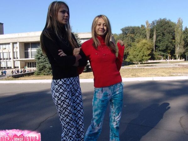 10P Young lesbians Laura and Katrina kiss on the lips while fully clothed