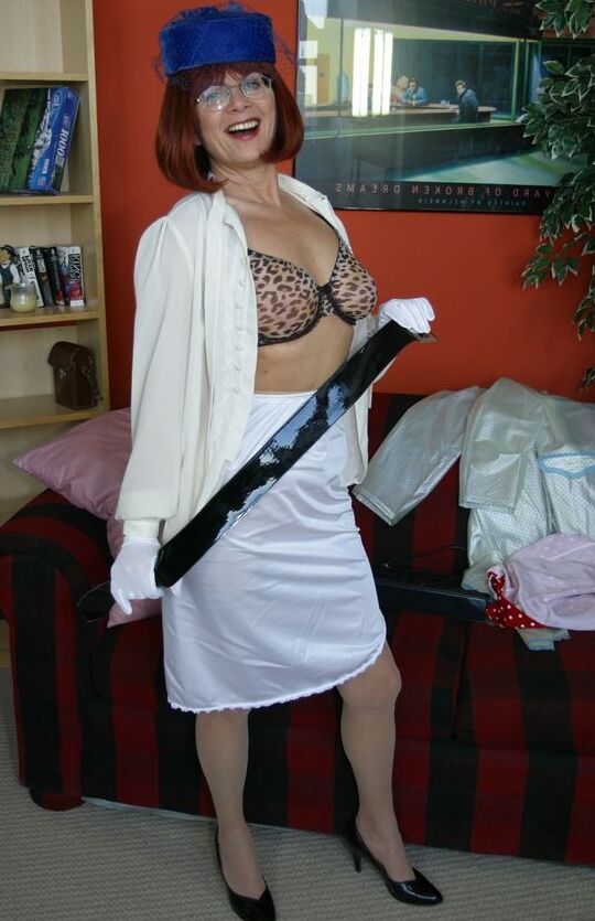 12P Old amateur Miss Abigail slips hose over satin underwear while wearing a hat