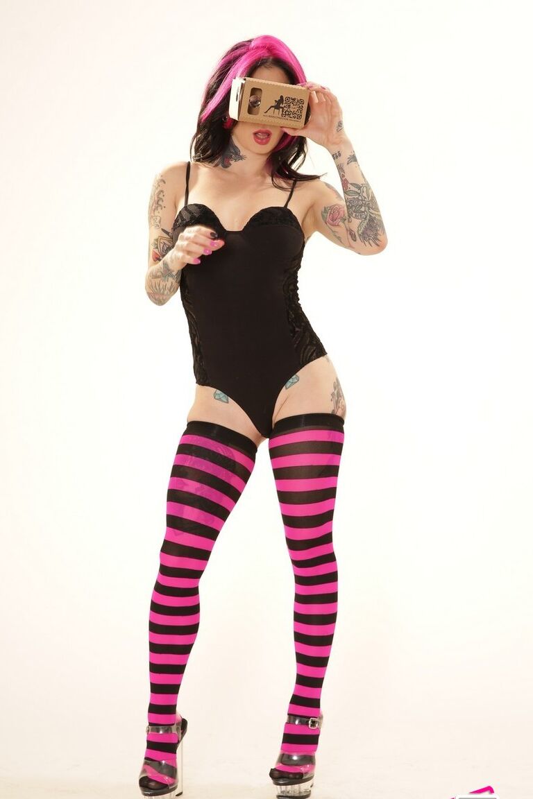 21P Inked wife in a bodysuit Joanna Angel poses with a VR set in her hands