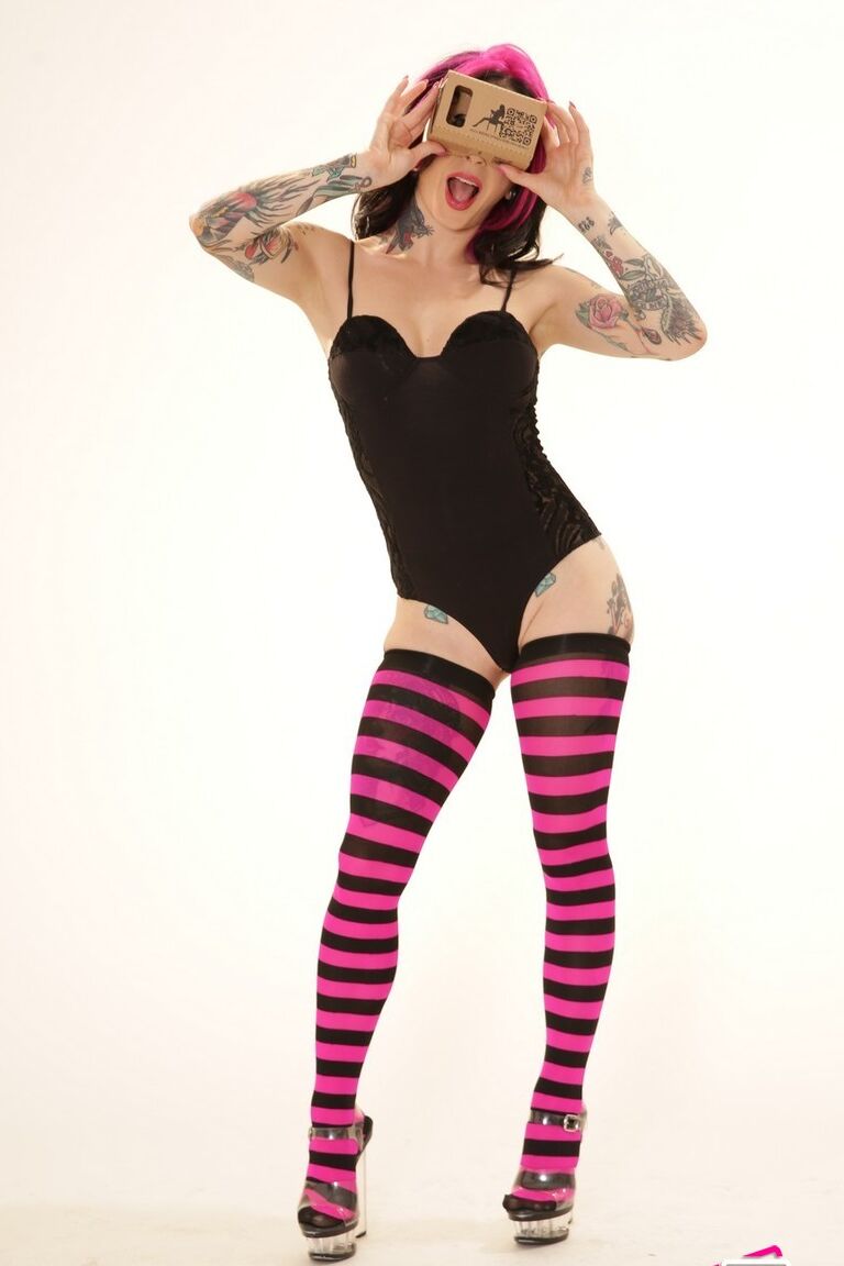21P Inked wife in a bodysuit Joanna Angel poses with a VR set in her hands