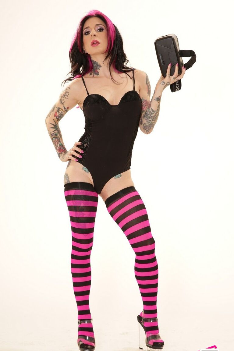 21P Inked wife in a bodysuit Joanna Angel poses with a VR set in her hands