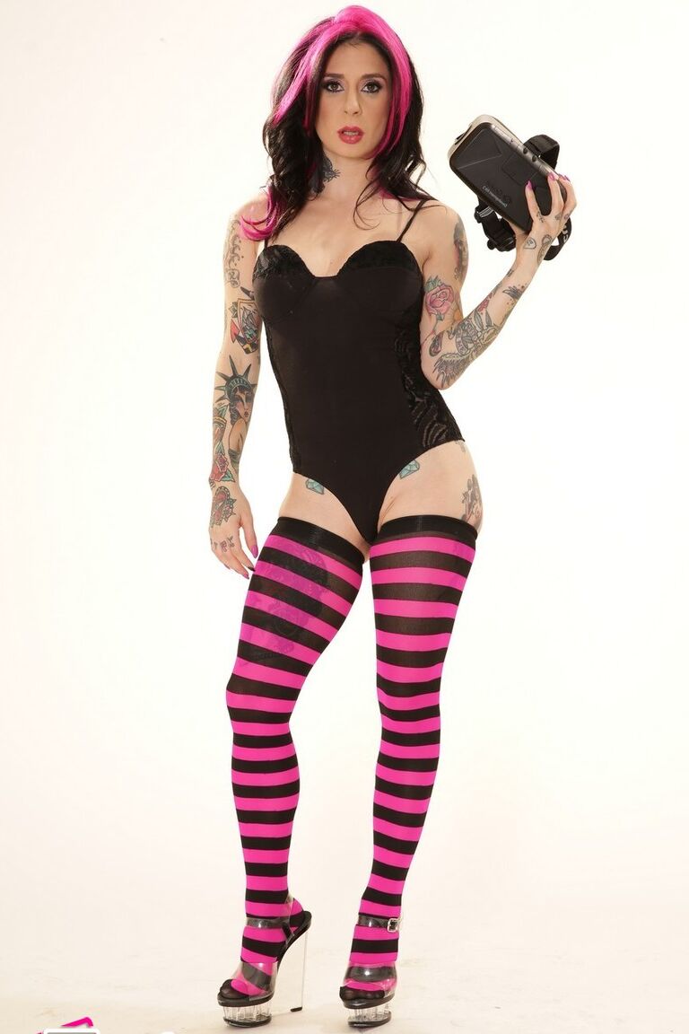 21P Inked wife in a bodysuit Joanna Angel poses with a VR set in her hands