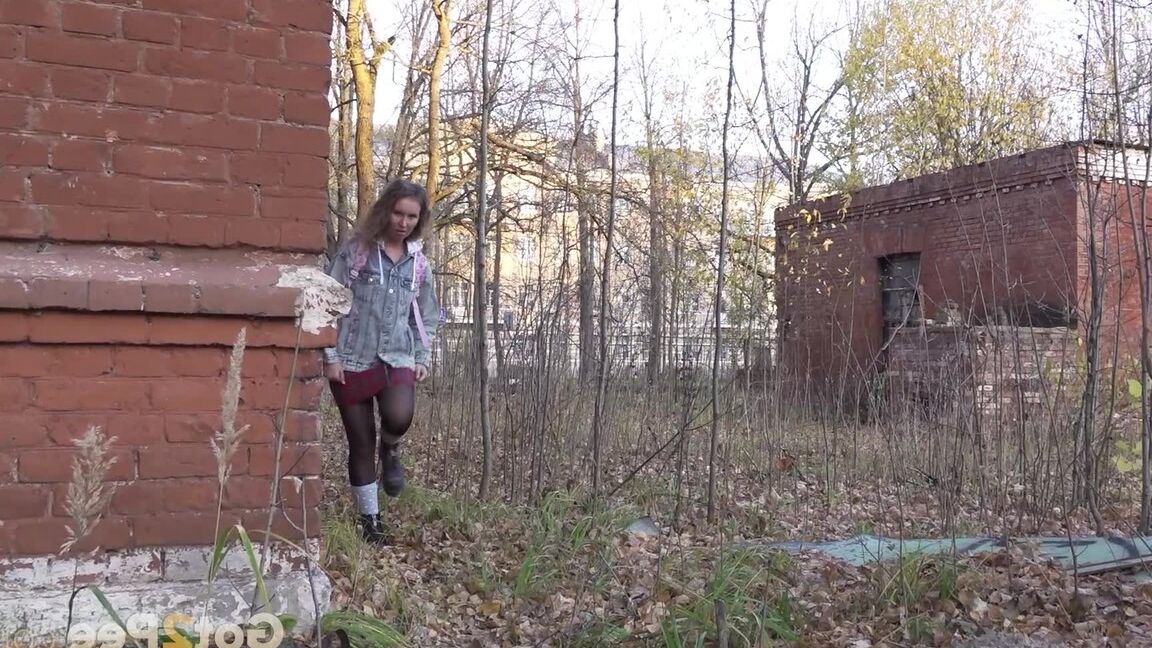 15P White girl Rita bares her bum while taking a piss by an abandoned building
