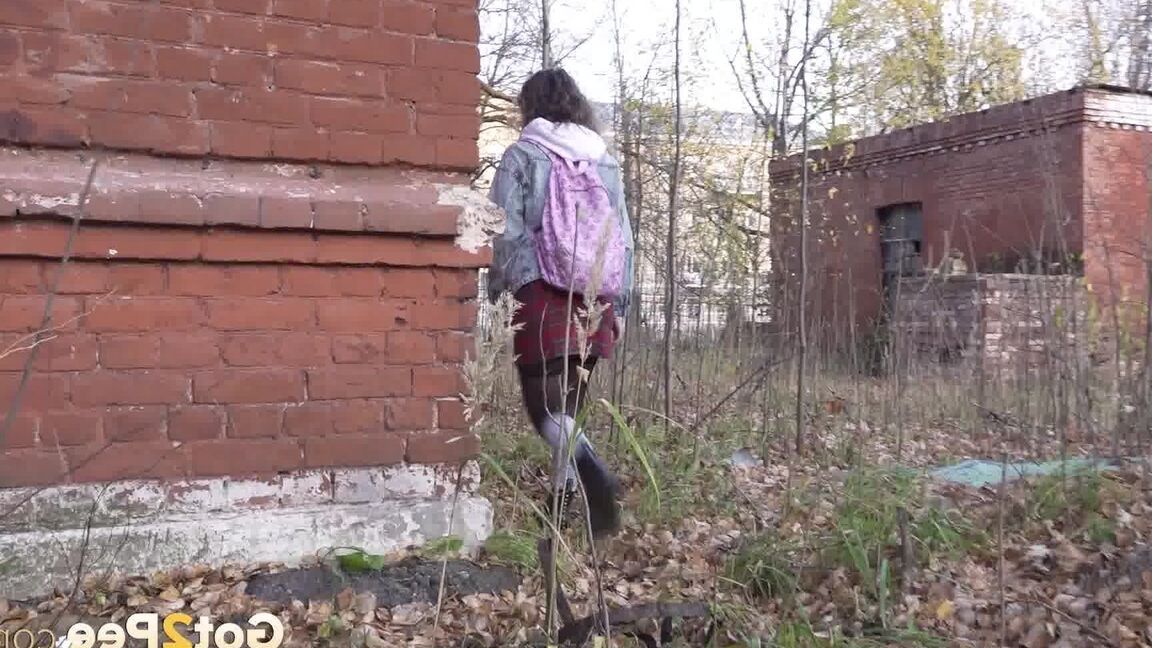 15P White girl Rita bares her bum while taking a piss by an abandoned building