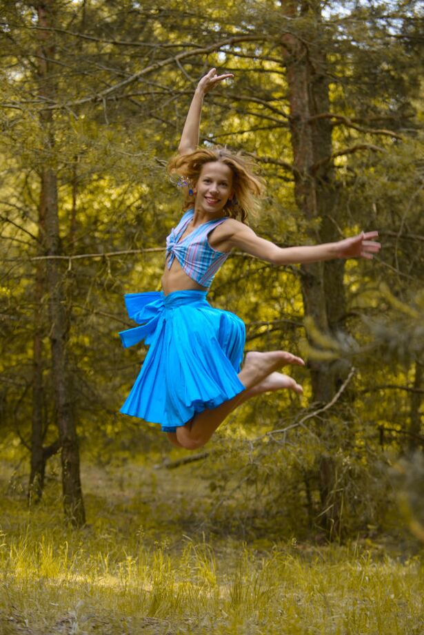 16P Caucasian model poses her skinny body in a clearing in the forest