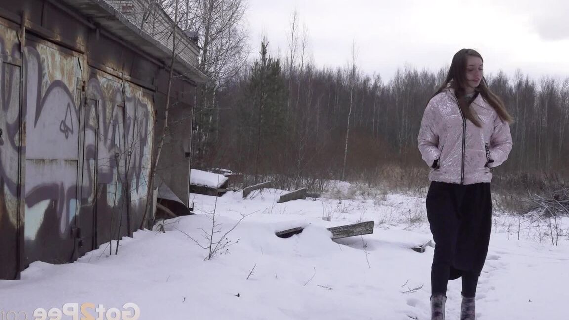 15P Distressed girl takes a piss on a table in an abandoned building