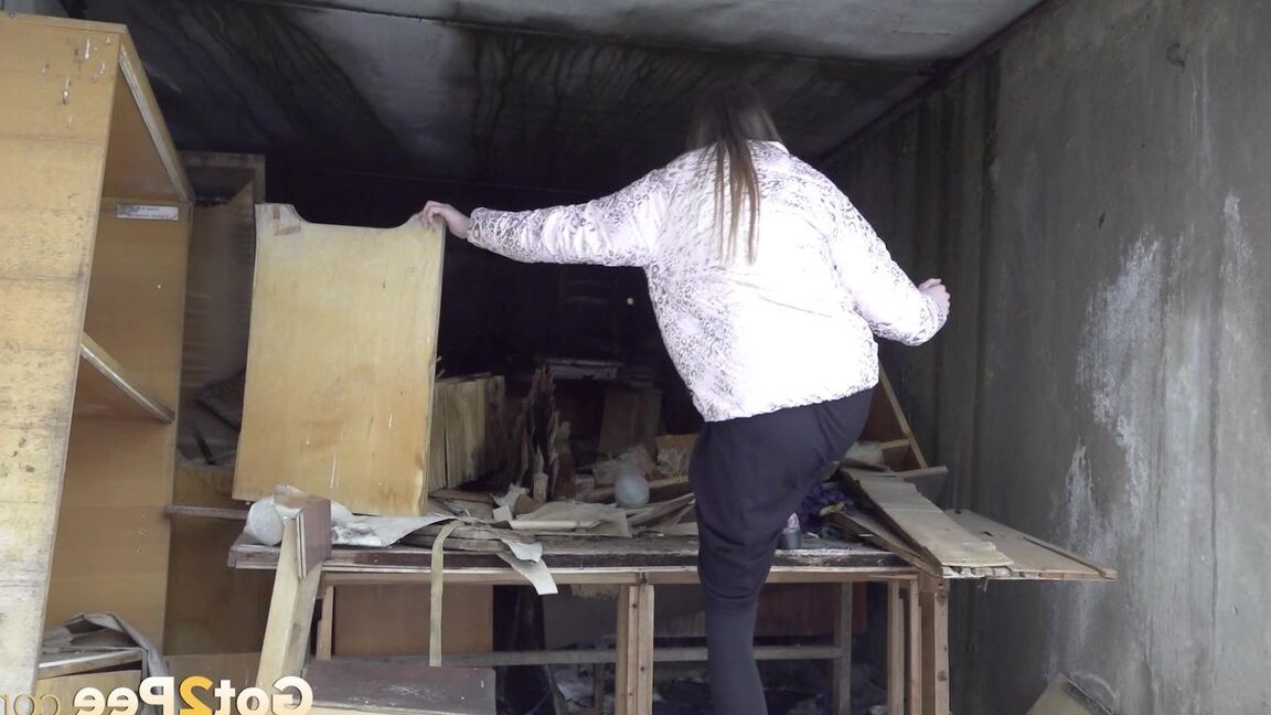 15P Distressed girl takes a piss on a table in an abandoned building