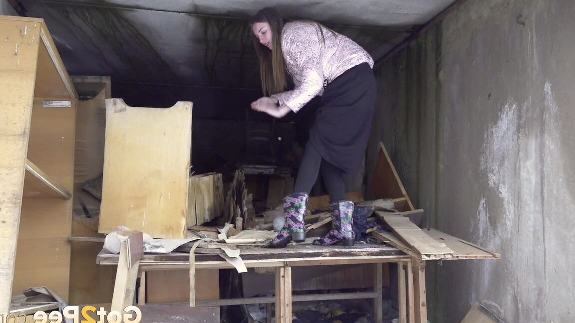 15P Distressed girl takes a piss on a table in an abandoned building