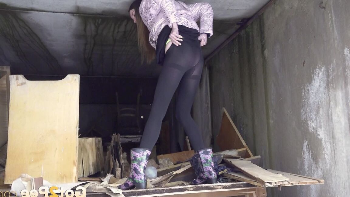 15P Distressed girl takes a piss on a table in an abandoned building