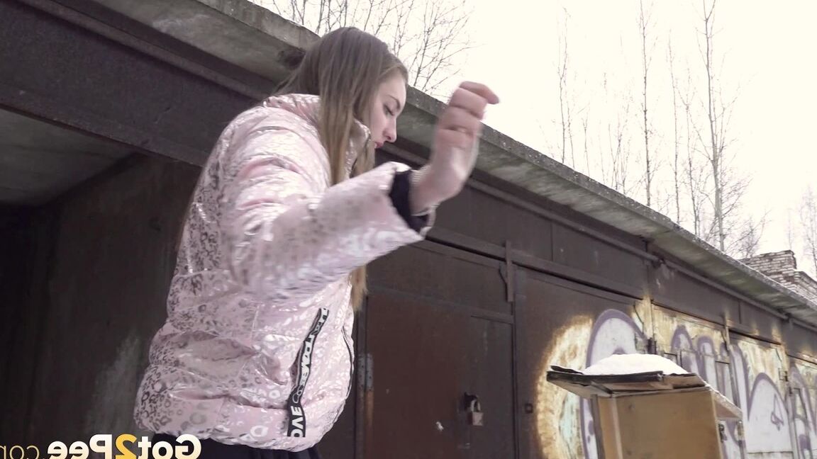 15P Distressed girl takes a piss on a table in an abandoned building