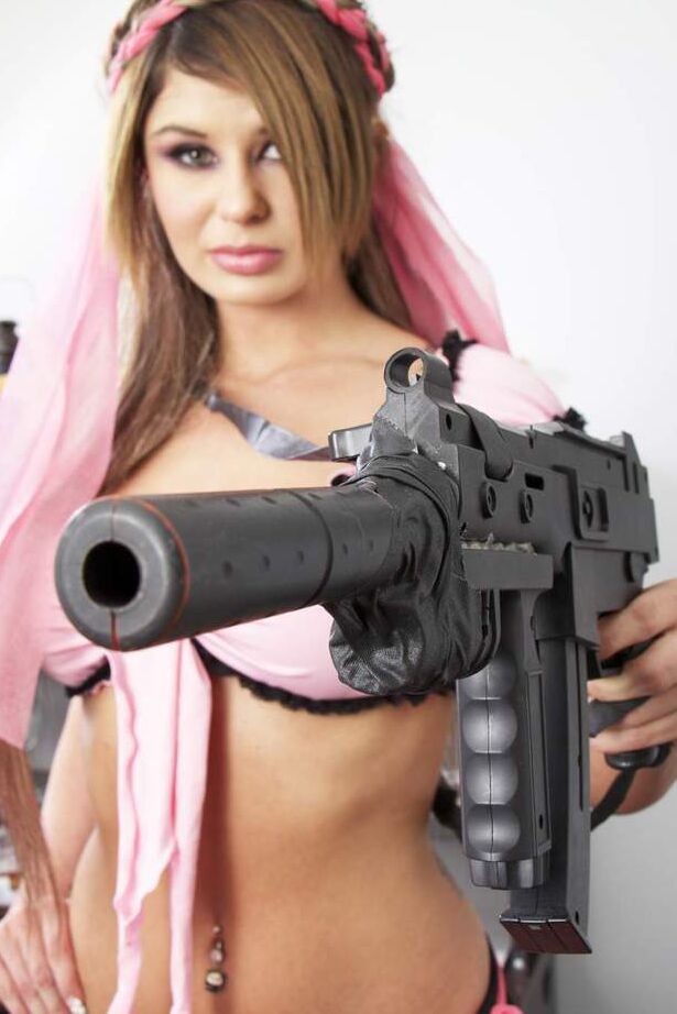 16P A estrela pornô Chloe Chaos abaixando a calcinha enquanto segura uma arma
