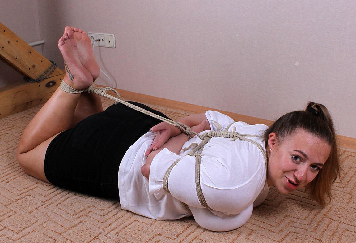 16P Caucasian female Charlotte is hogtied while wearing a blouse and miniskirt