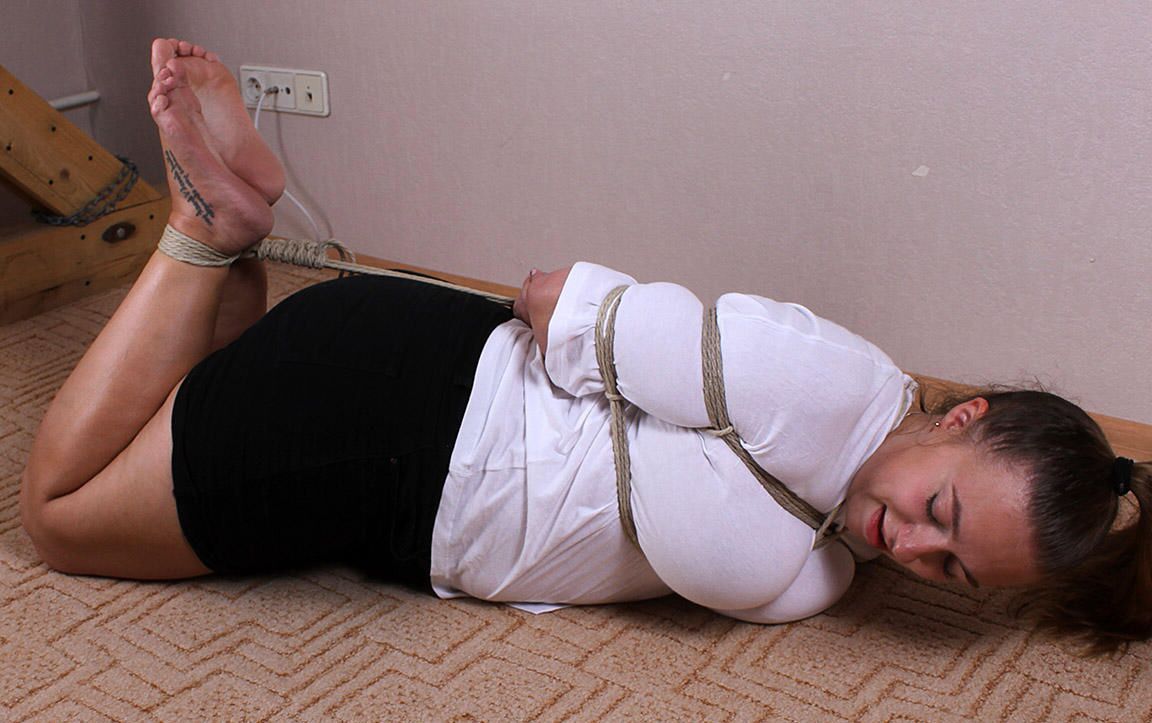 16P Caucasian female Charlotte is hogtied while wearing a blouse and miniskirt