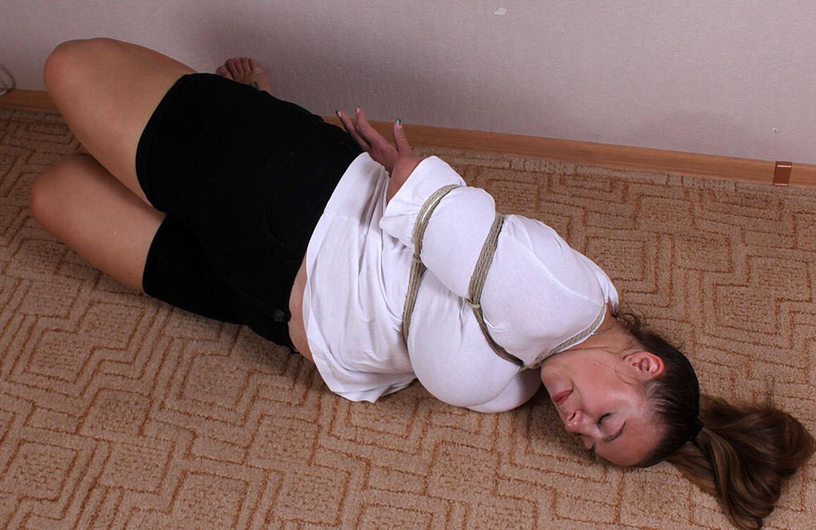 16P Caucasian female Charlotte is hogtied while wearing a blouse and miniskirt
