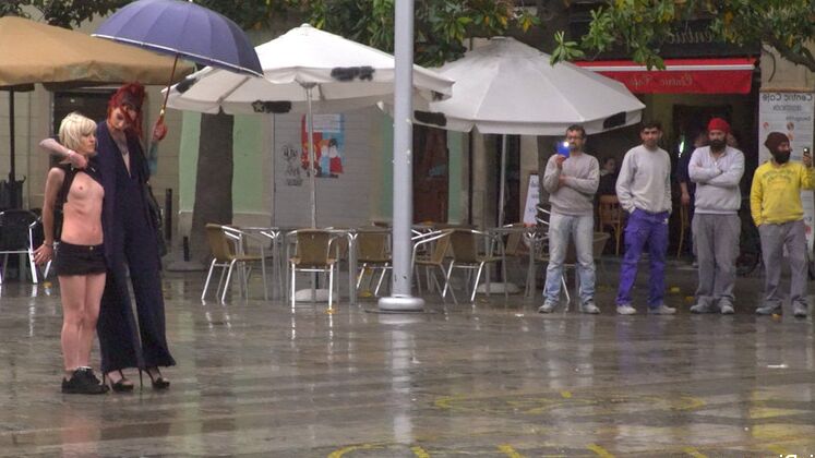 15P Nora Barcelona is humiliated in a rainy Barcelona square before being brought