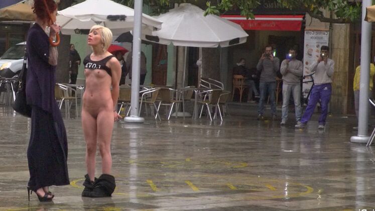15P Nora Barcelona is humiliated in a rainy Barcelona square before being brought