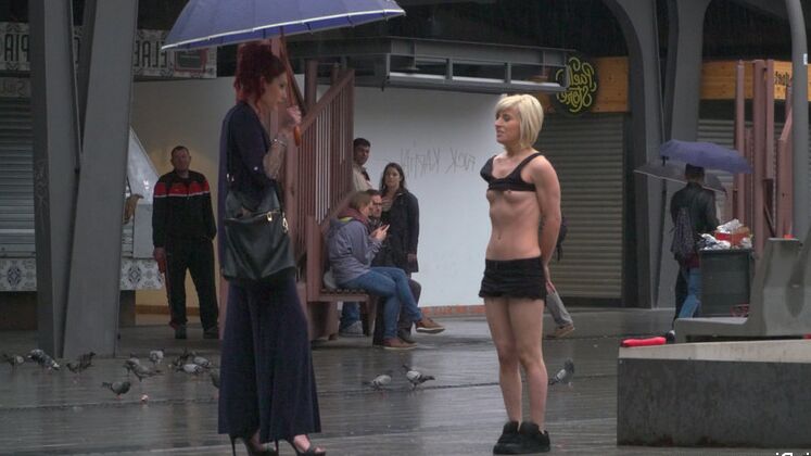 15P Nora Barcelona is humiliated in a rainy Barcelona square before being brought