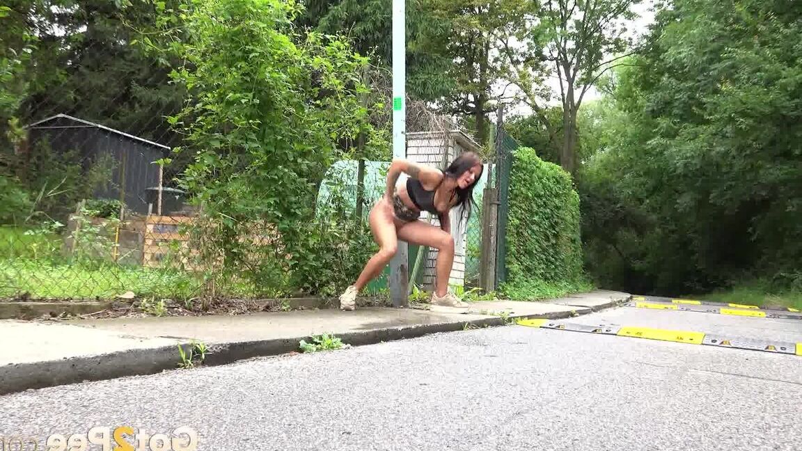 15P Solo girl Isabel Dark lets loose with a stream pf piss on a public sidewalk