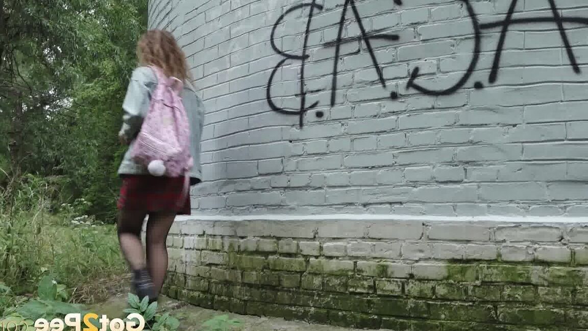 15P Solo girl Rita wipes herself after taking a piss near a graffitied building