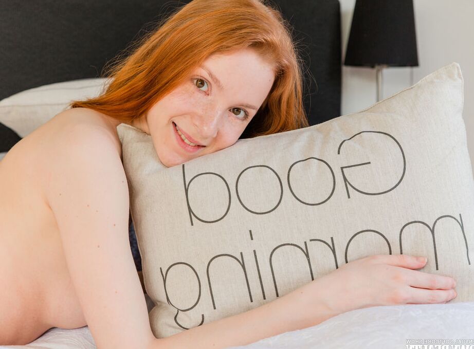 20P Young looking redhead Amberlyn hangs out on her bed while totally naked