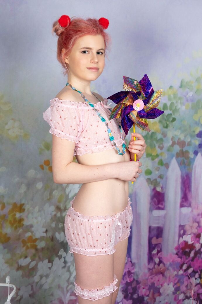 20P Young looking girl Sally gets naked while wearing a garter in puffballs