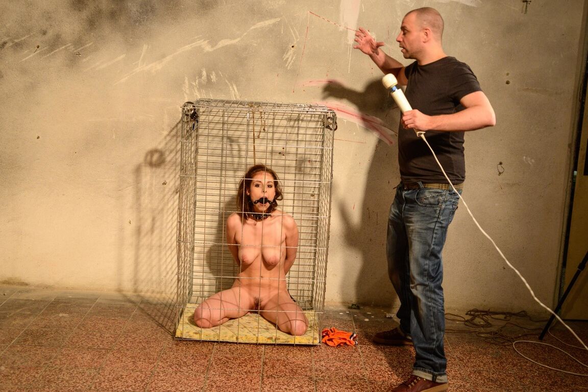 12P Ball gagged and restrained sex slave is masturbated while inside a cage
