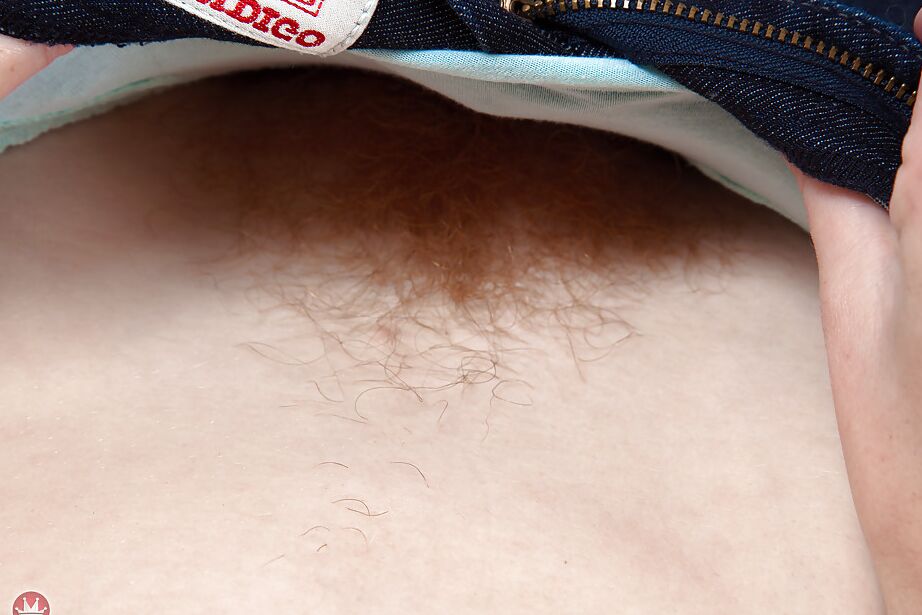 16P Redhead solo model Tia Jones showing off hairy cunt after doffing jeans