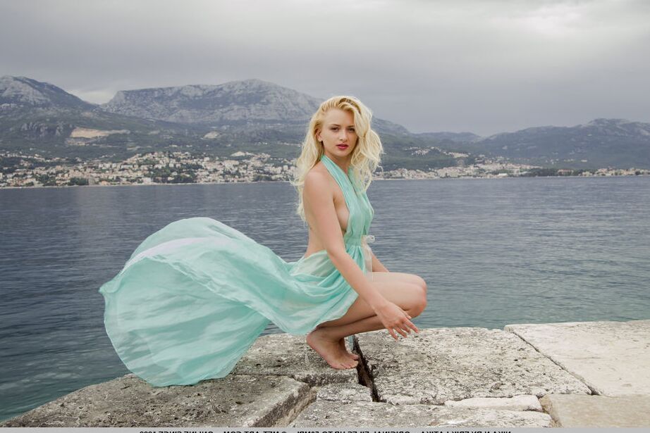 18P Young blonde Nika Ngets wet while striking great seaside poses in lingerie