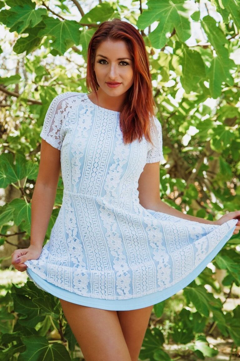 12P Redheaded beauty Harley Gacke strips naked in a garden setting