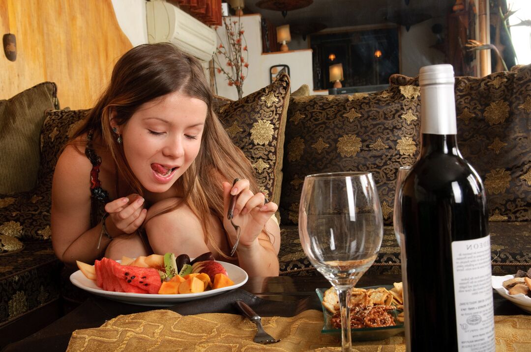 15P Cute young girl goes topless while enjoying a fruit plate and bottle of wine