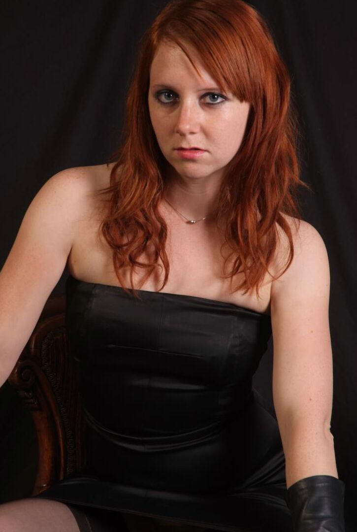 15P Une rousse sexy fléchit une canne avant de toucher sa fente serrée avec des gants en cuir